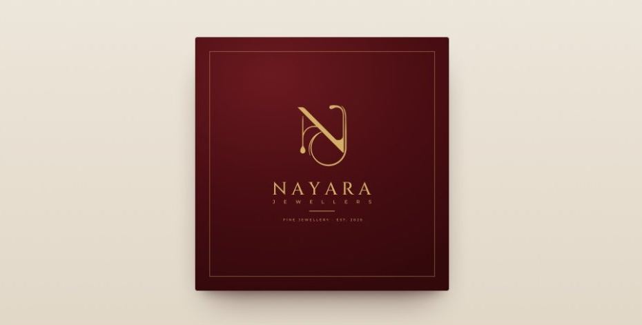 Nayara Jewellers monogram in antique gold on an imperial maroon card